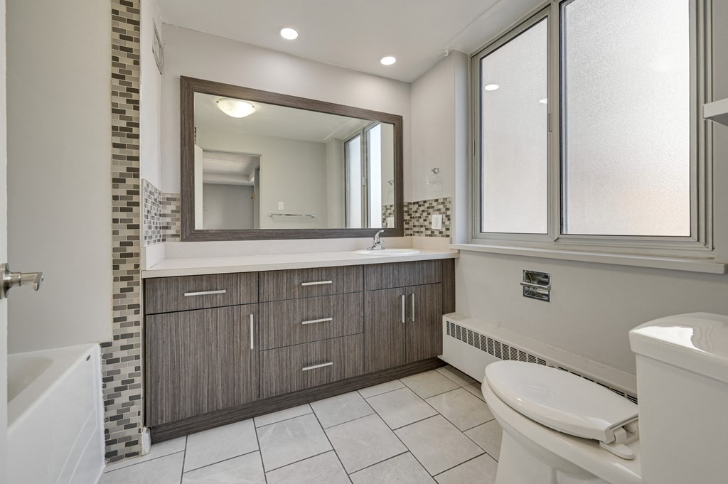 a bathroom with a sink toilet and a mirror
