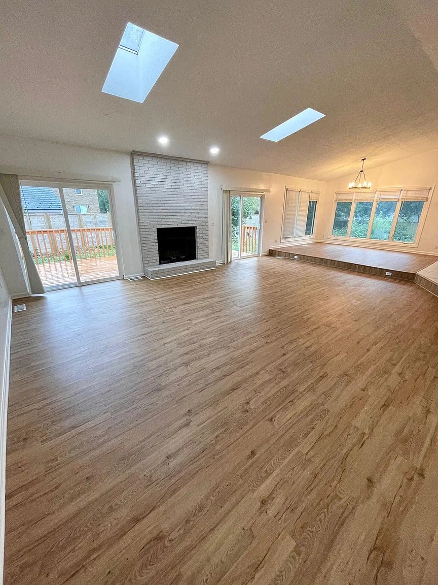 a living room with a fireplace and a wooden floor