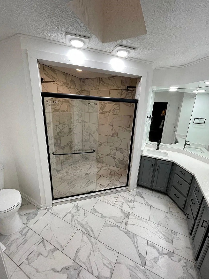 a bathroom with a shower and a sink and a toilet