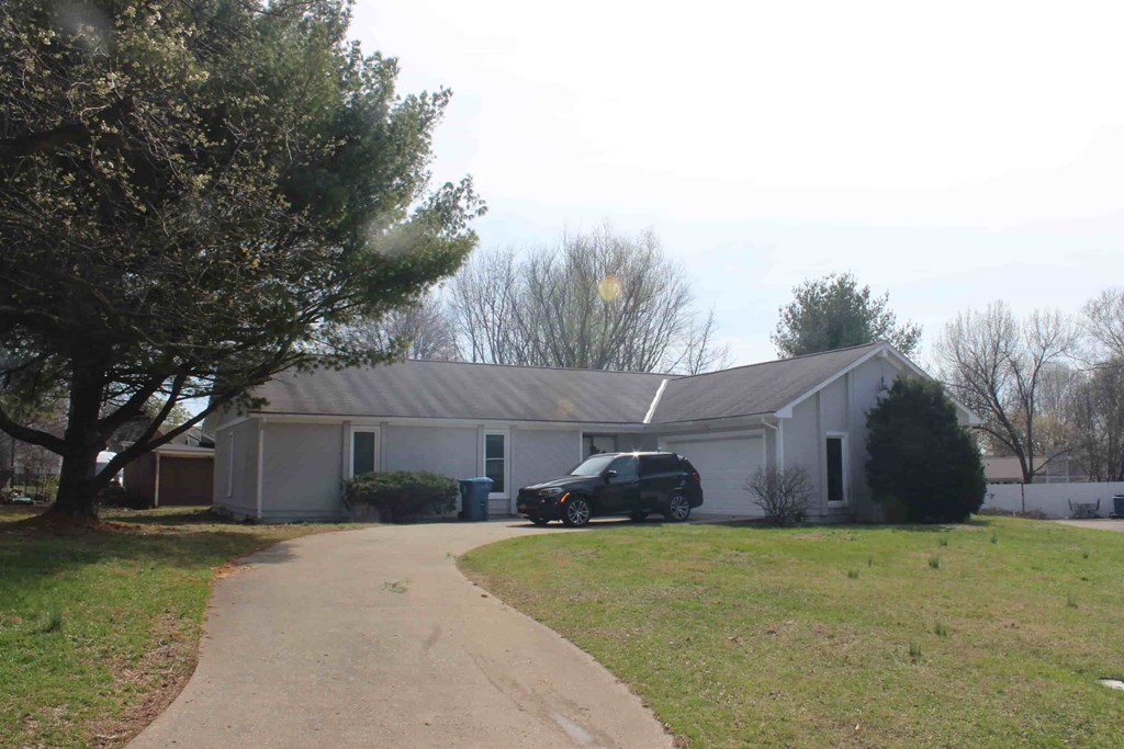 a white house with a car parked in front of it