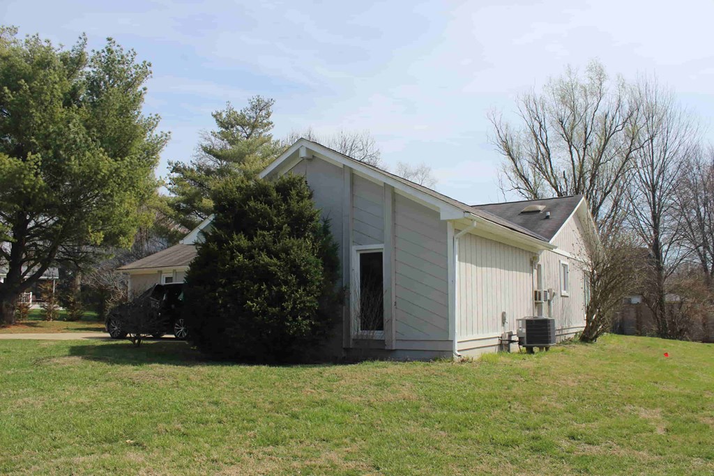 a small white house with a yard in front of it