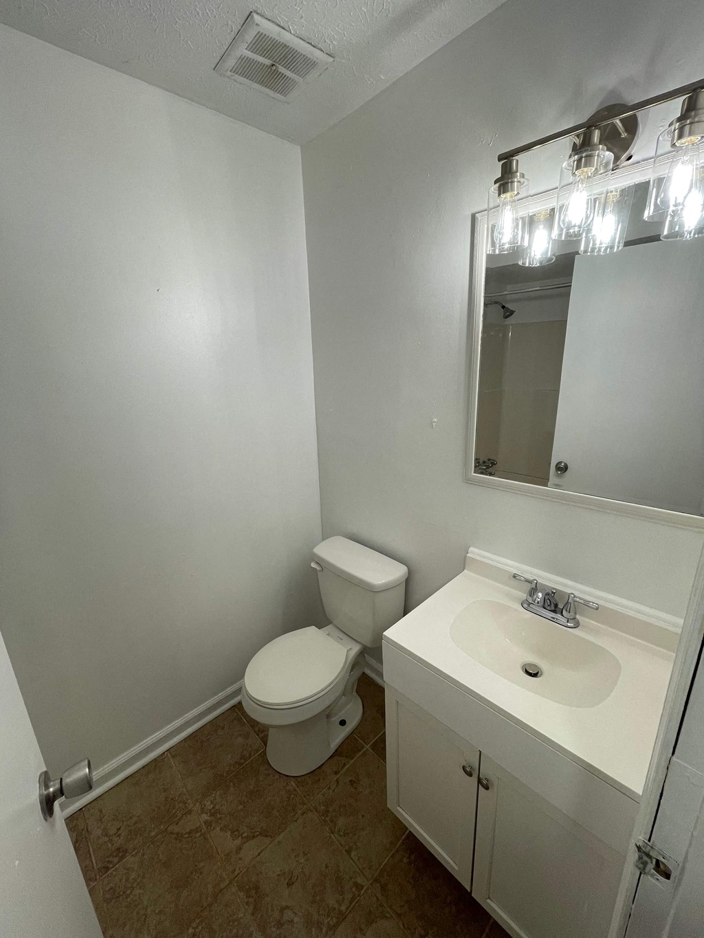 a bathroom with a sink and a toilet and a mirror