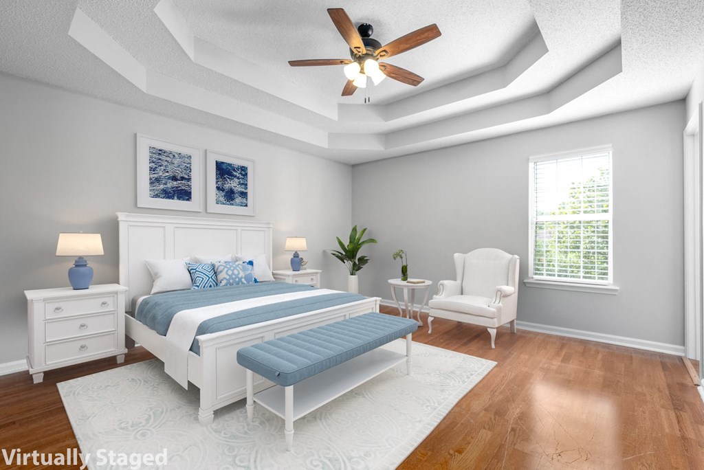 a bedroom with a bed and a ceiling fan