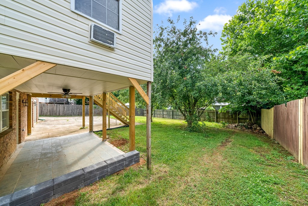the back of a house with a yard and a deck