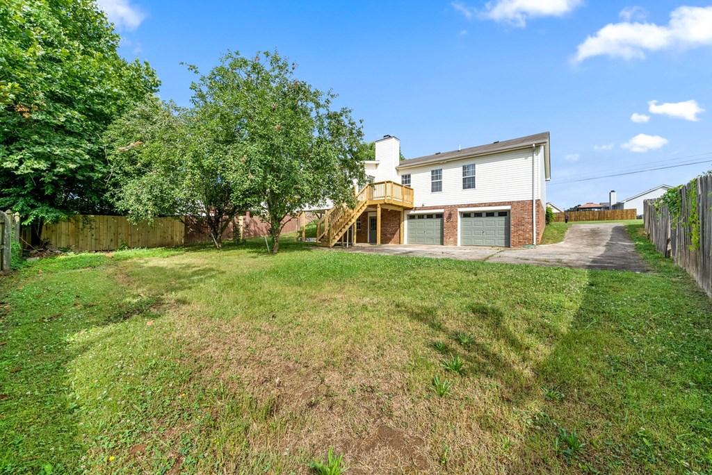 a backyard with a house with a yard and a staircase