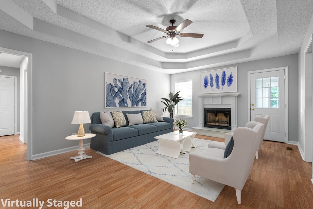 a living room with a ceiling fan and a couch