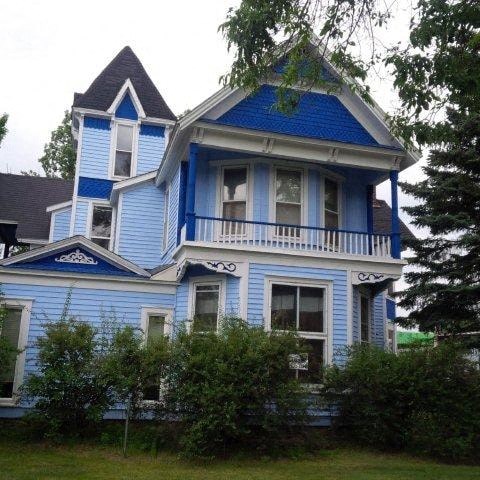 a blue and white house with a blue roof