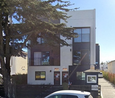 a white car parked in front of a building