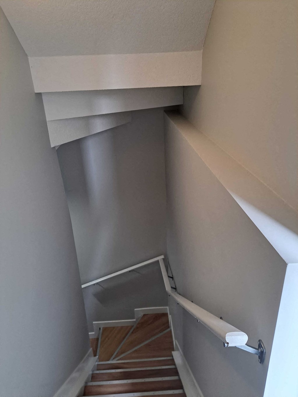 looking down the stairs from the third floor of a house