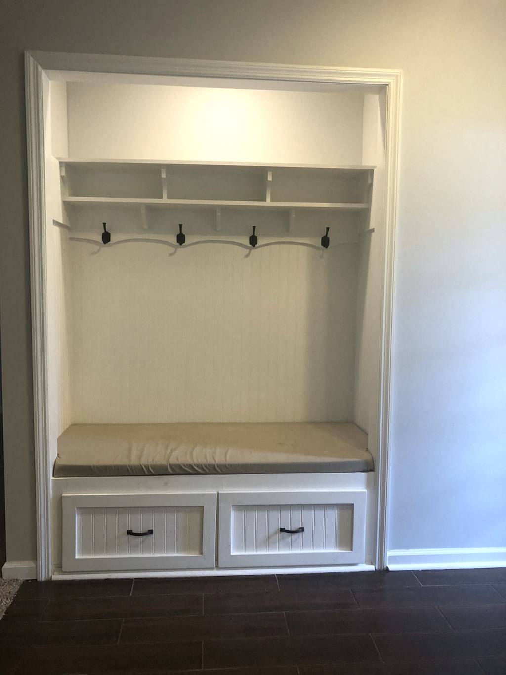 an empty closet with a bench and shelves