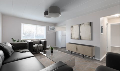 A modern living room with a black leather couch and a glass coffee table.