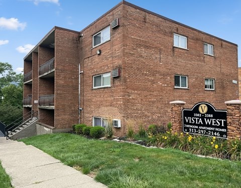 A brick building with a sign that says Vista West in front of it.