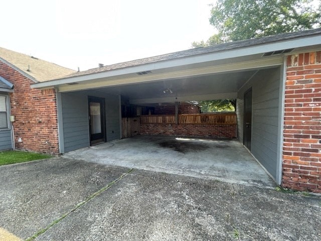 a garage with the door open on a brick house