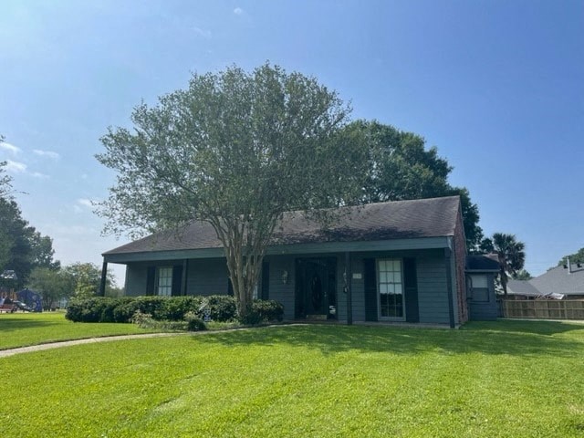 a green house with a tree in the yard
