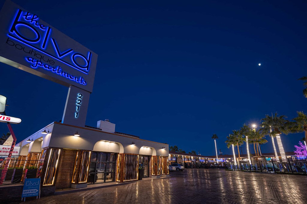 a city at night with the facade of the olivo supermarket