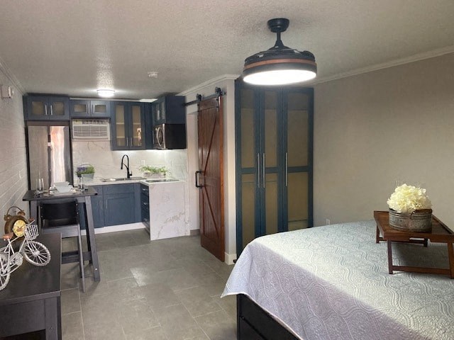 a small kitchen and a bed in a room