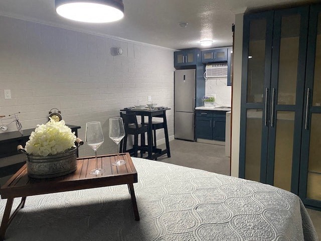 a small room with a bed and a table with a basket of flowers