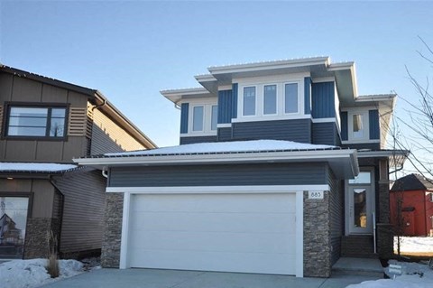 a house with a white garage door in front of it