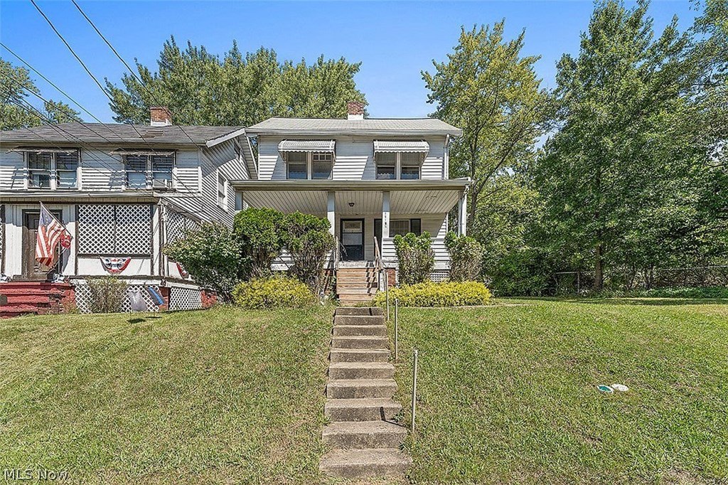 a blue house with stairs in front of it