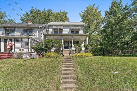 a blue house with stairs in front of it