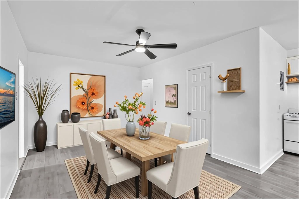 A dining room with a wooden table and chairs.