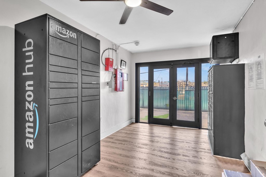 A room with a wall unit labeled "Amazon Hub" and a ceiling fan.