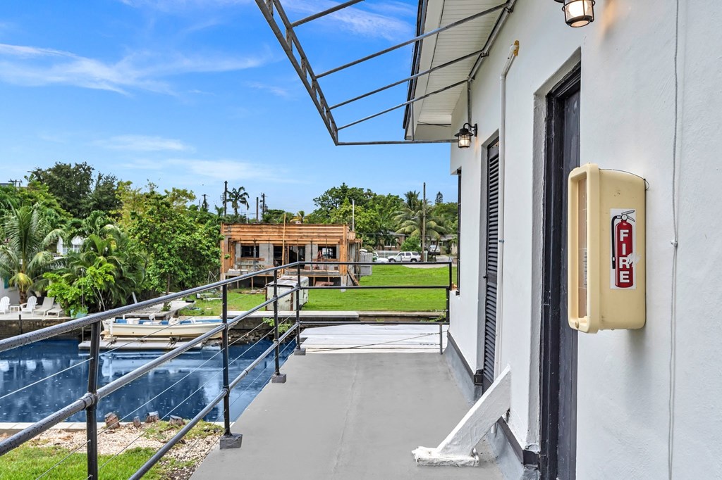 a balcony with a view of a pool and a building
