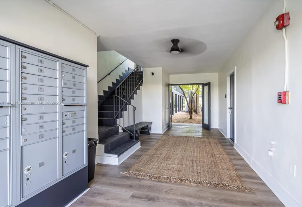 a hallway with lockers and a staircase in a house