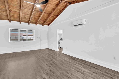A room with wooden floors and a ceiling fan.
