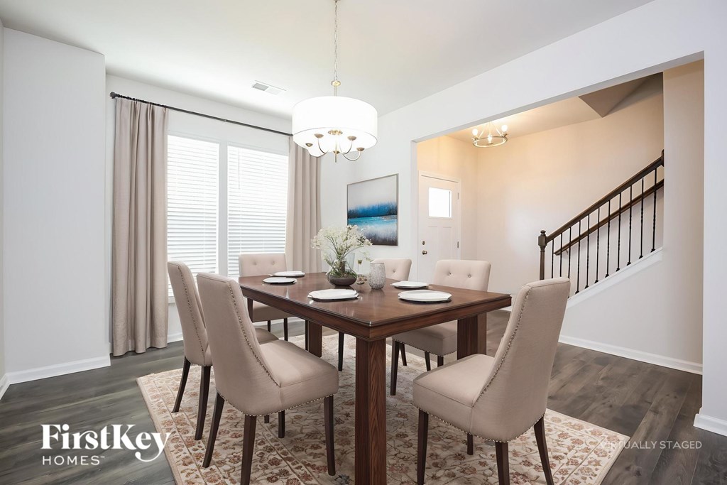 A dining room with a wooden table and chairs.
