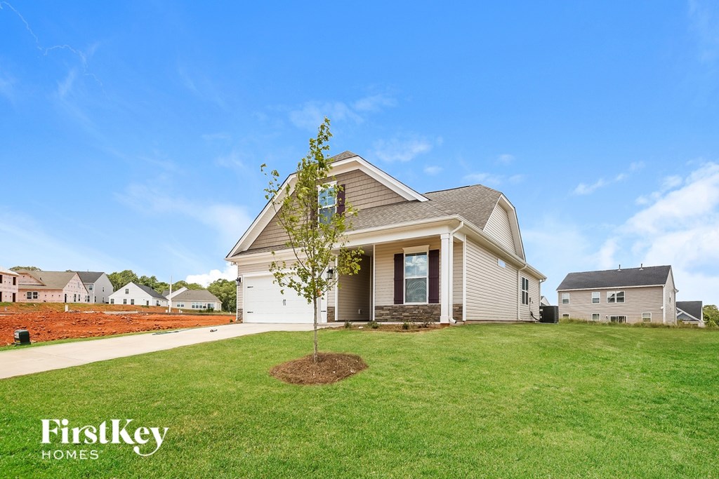 A house with a tree in front of it and the words "FirstKey Homes" on the bottom left.
