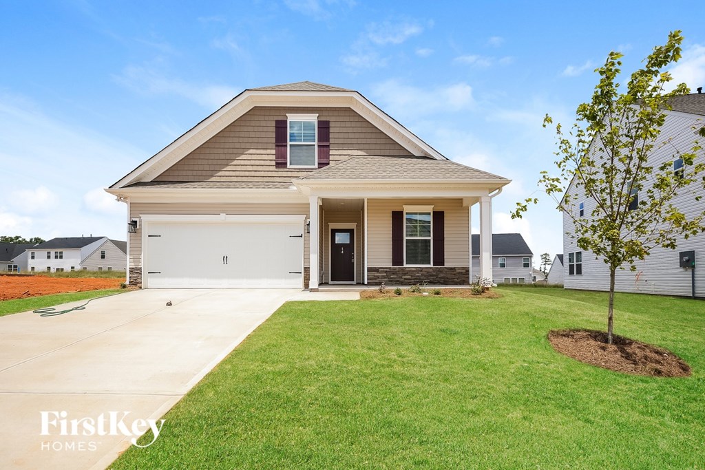 A house with a brown roof and a white garage door is for sale.