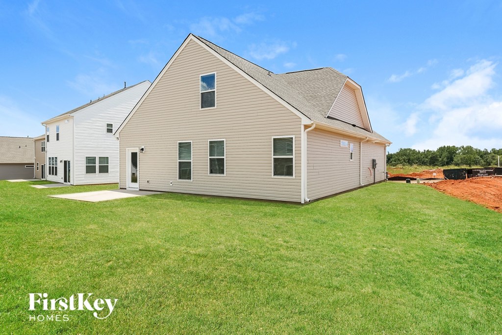 A house with a lawn in front of it.