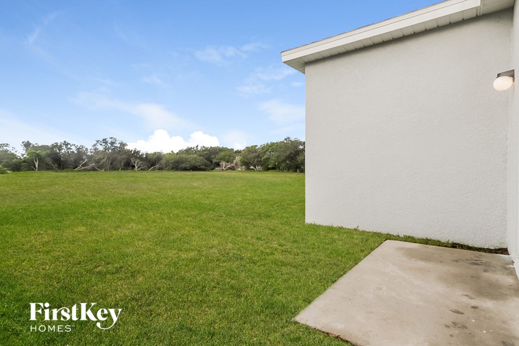 the backyard of a house with a lawn and a garage
