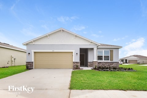 A house with a garage door that is closed.