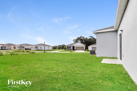A grassy field with a FirstKey Homes logo.