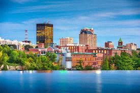 a cityscape of the city with a lake and a fountain