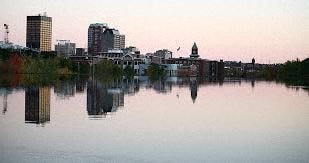 a body of water with a city in the background