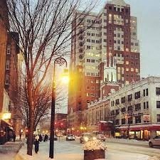 a city street with a street light and tall buildings