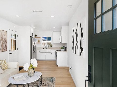 a living room with a kitchen and a table