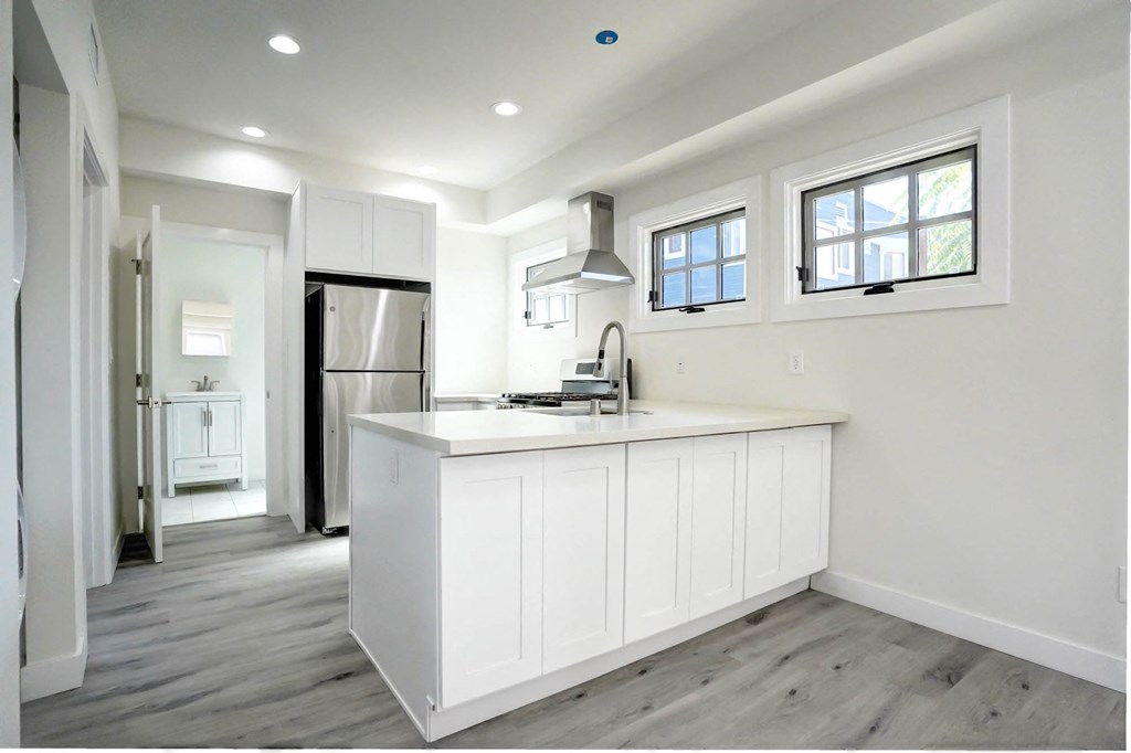 a kitchen with white cabinets and a white counter top
