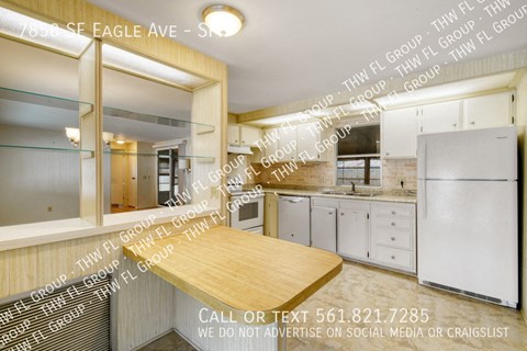 an image of a kitchen with a table and a sink
