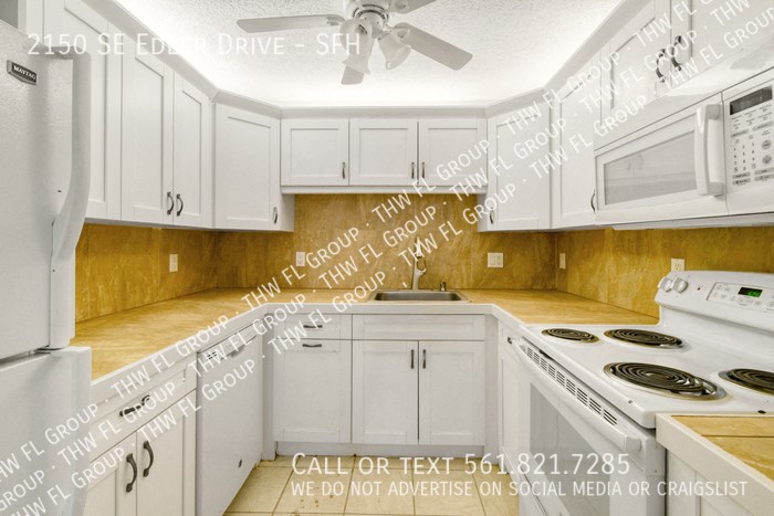 rendering of a kitchen with white cabinets and white appliances
