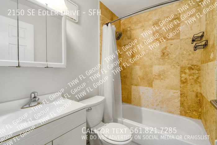 a bathroom with a shower and a sink and a toilet