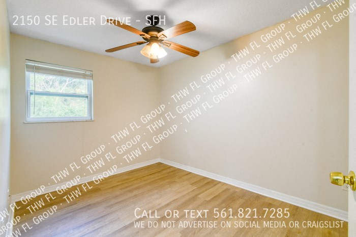an empty room with a ceiling fan and words on the wall