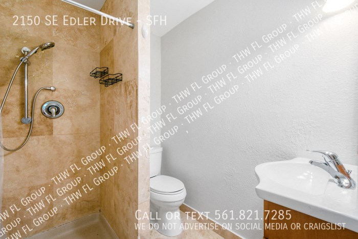 a bathroom with a shower and a sink and a toilet