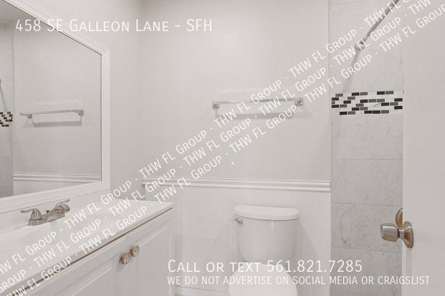 a white bathroom with white writing on the wall and a white toilet