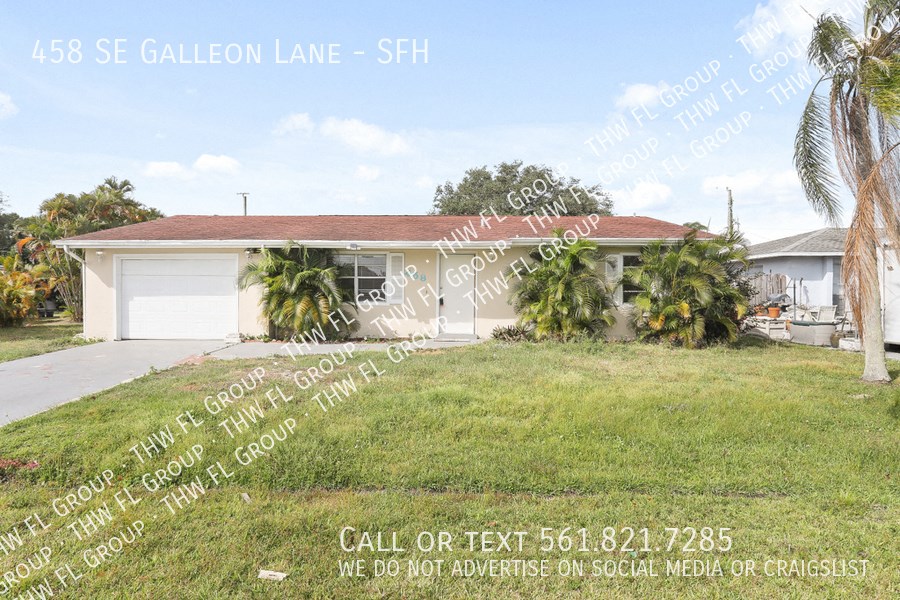 a house with palm trees in front of it and a lawn