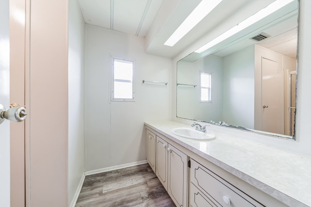an empty bathroom with a sink and a mirror