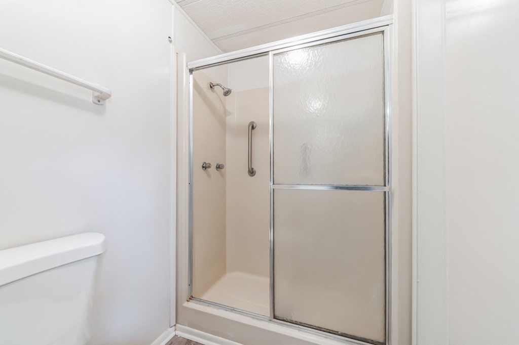 a small bathroom with a shower and a toilet